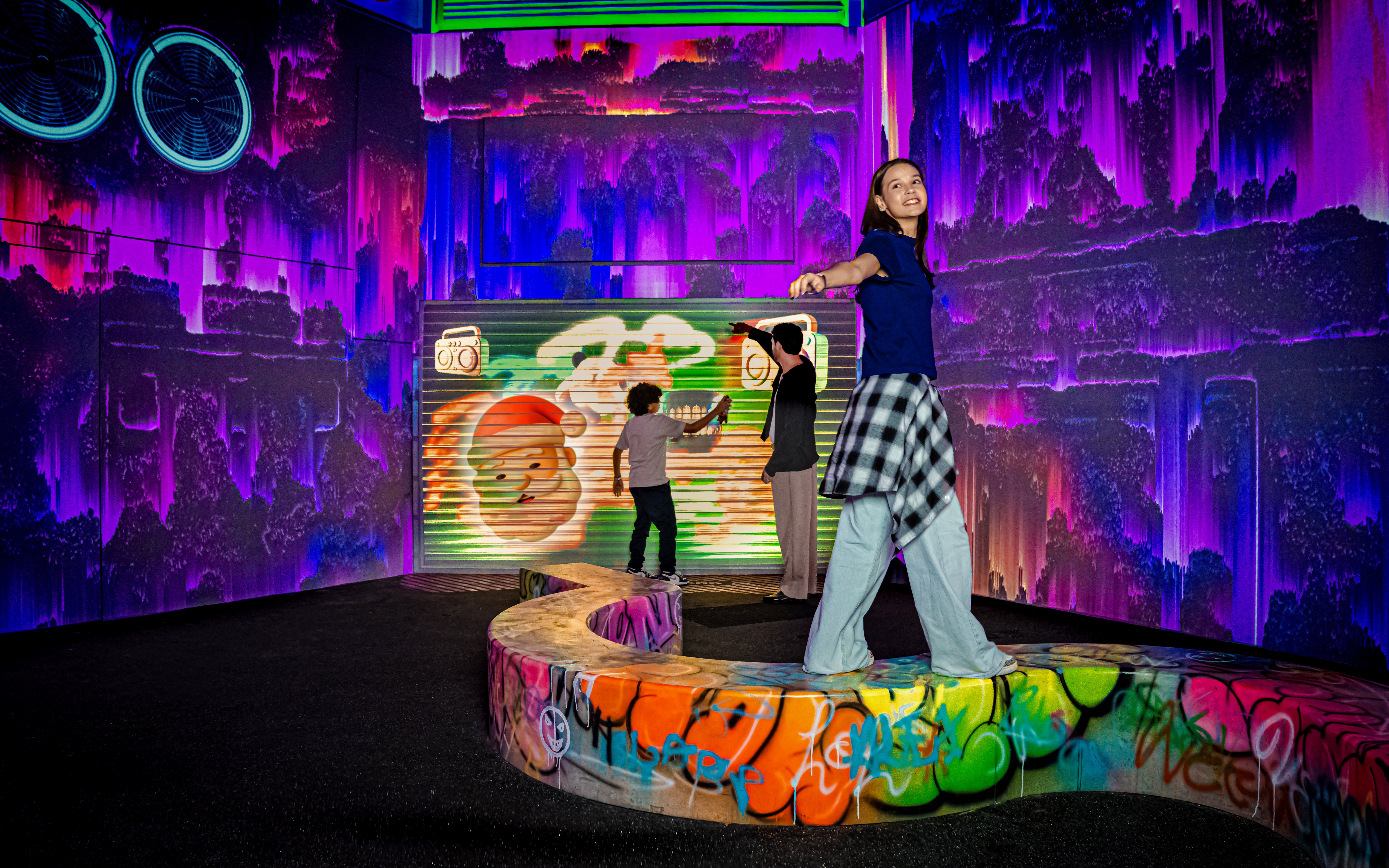 Visitors exploring vibrant graffiti art at House of Hype.