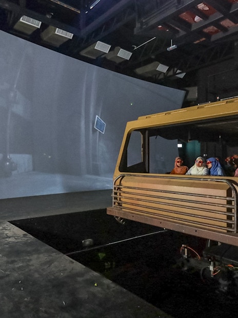 Tourists experiencing SkyRex show with 3D simulations and 4D effects in a theater setting.