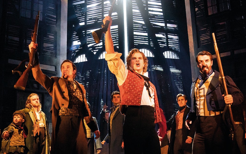 Actors performing a revolutionary scene in Les Miserables musical.