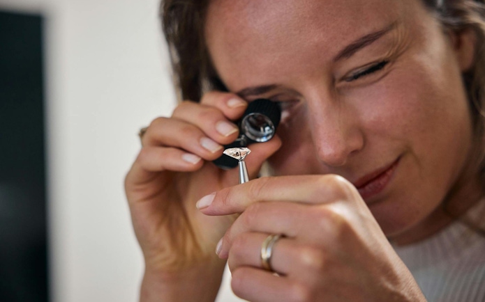 Examining a diamond with a loupe at the oldest diamond factory in the world.