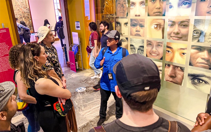 Visitors listening to a guide at the Anthropology Museum in Mexico City.
