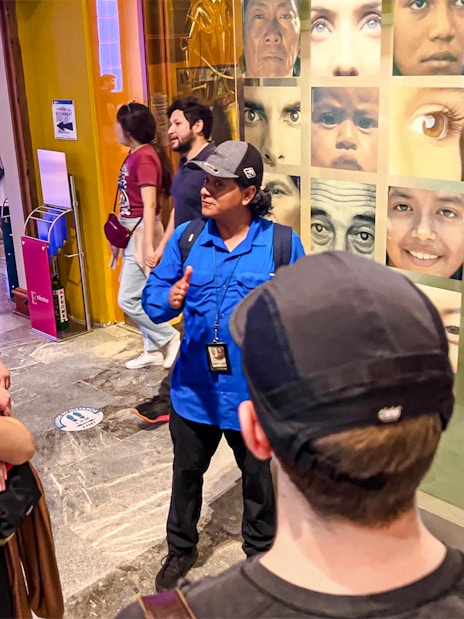 Visitors listening to a guide at the Anthropology Museum in Mexico City.