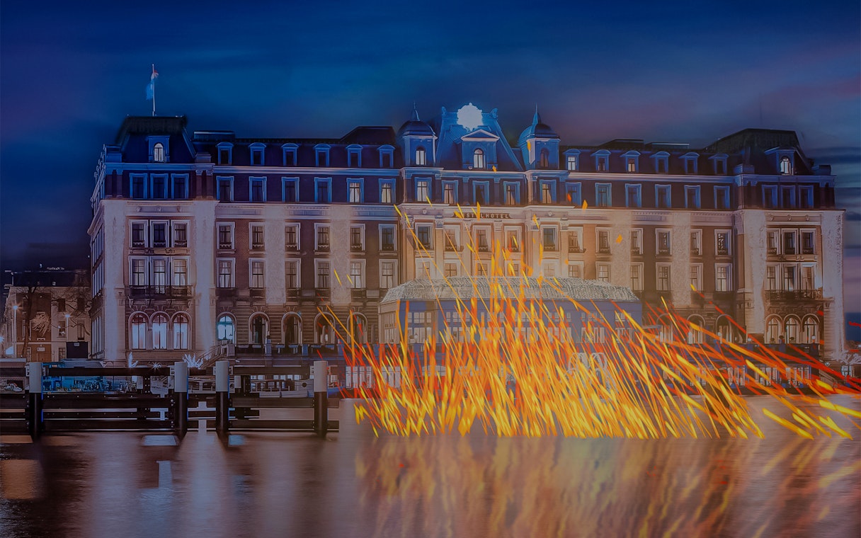 Amsterdam Light Festival installation with illuminated building and reflections on canal.