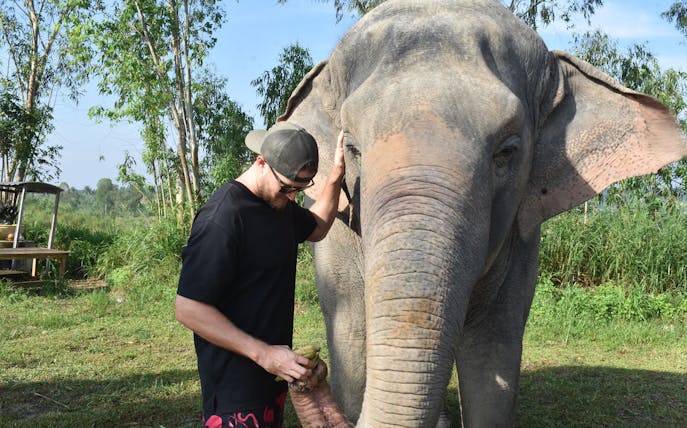 Man interacting with an elephant at Elephant Jungle Sanctuary, Pattaya.