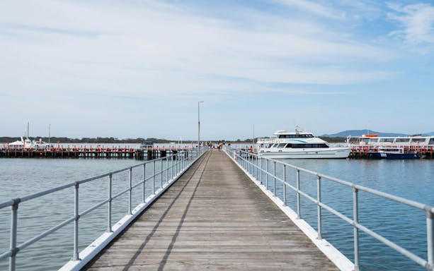 Pier leading to boats at Wilsons Prom for whale adventure cruise.