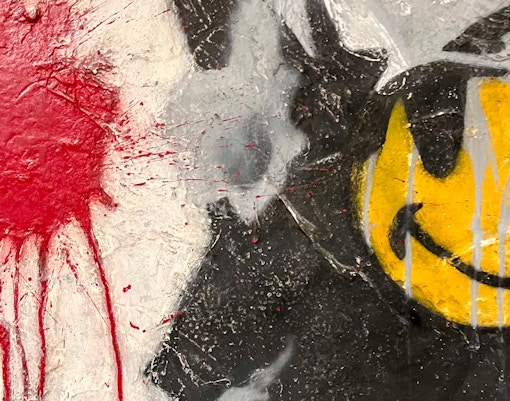 Banksy artwork of a smiling copper in London, showcasing street art culture.