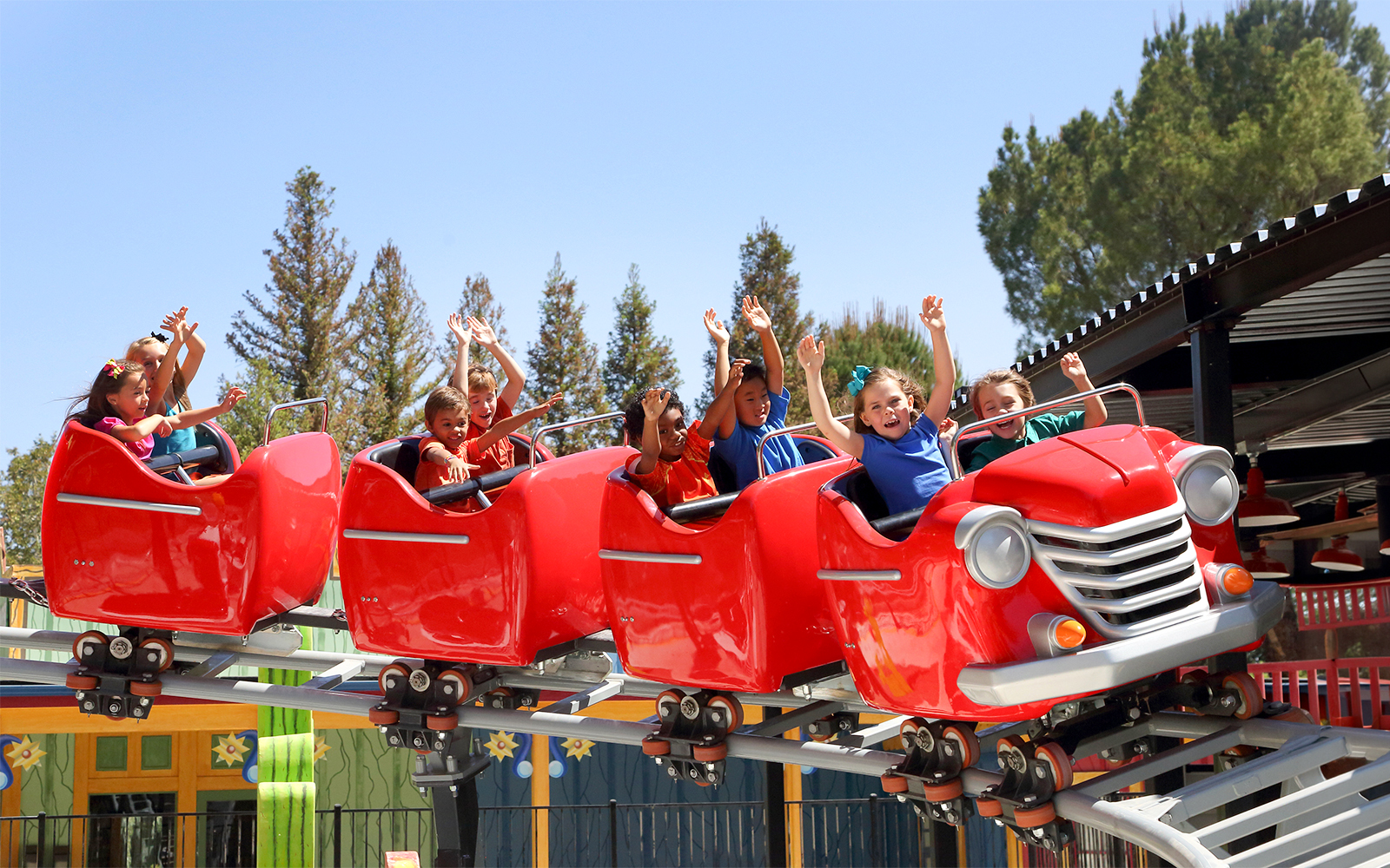 Children enjoying Speedy Gonzales Hot Rod Racers ride at Six Flags Magic Mountain.
