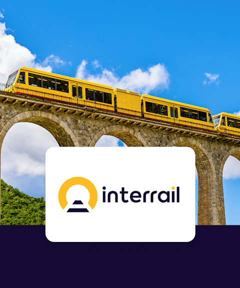 Yellow train crossing a stone viaduct with Interrail logo, promoting Global Flexible Pass.