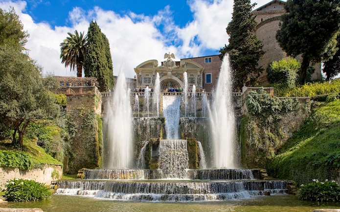 Fountains and gardens at Villa d'Este in Tivoli, Italy, with cascading water and lush greenery.