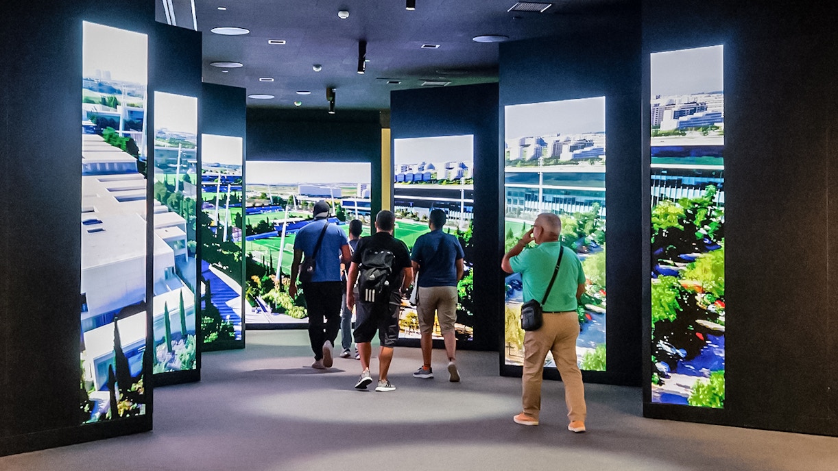 Tourists observing the exhibit at Santiago Bernabeu Stadium in Madrid, Spain.
