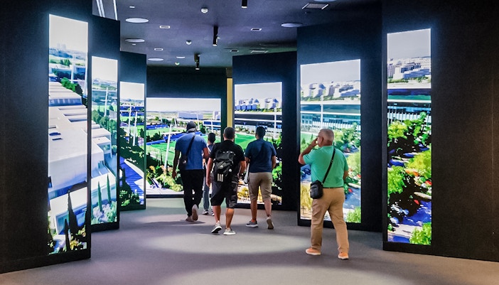 Tourists observing the exhibit at Santiago Bernabeu Stadium in Madrid, Spain.