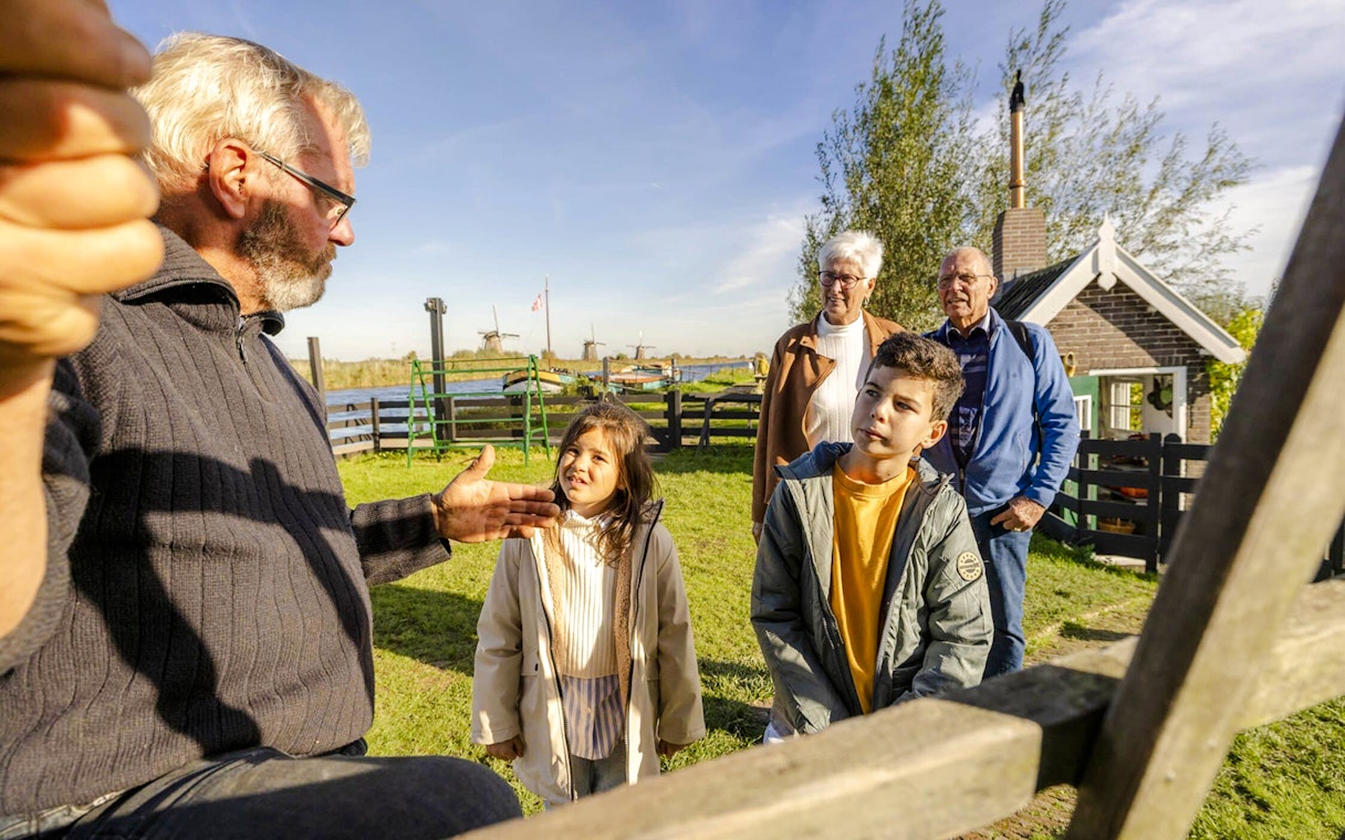 Family learning about windmills at Kinderdijk, Netherlands.