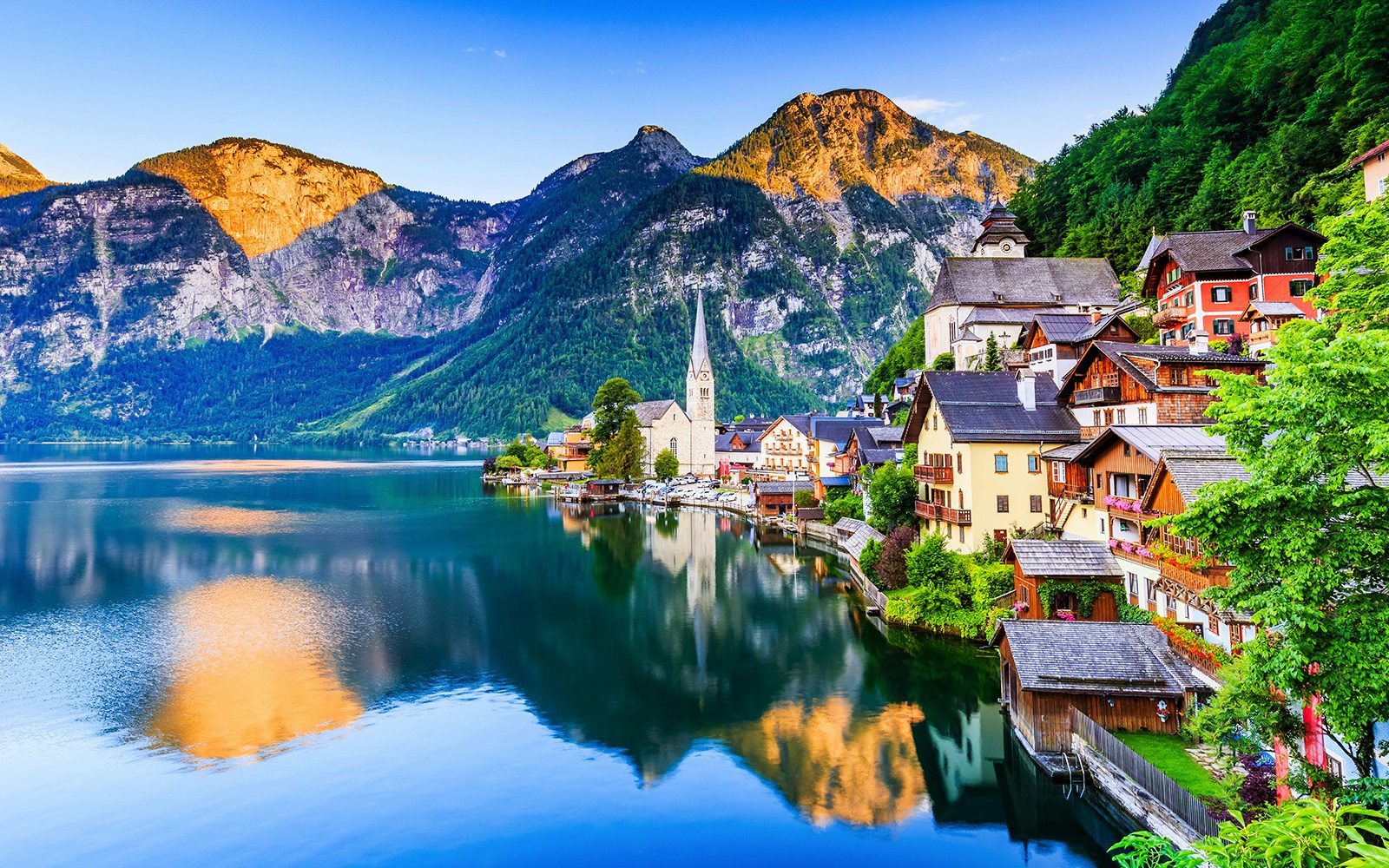 Village of Hallstatt by the lake with mountain backdrop in Salzkammergut, Austria.