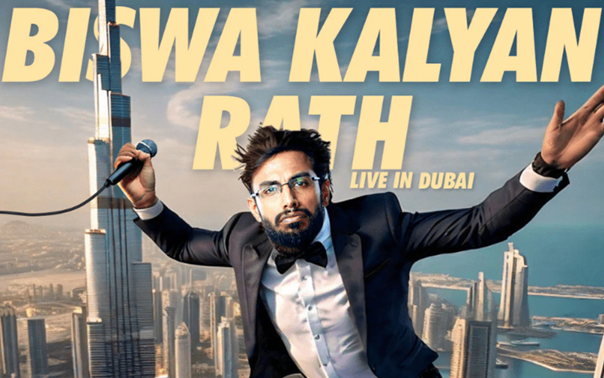 Comedian performing live in Dubai with Burj Khalifa in the background.