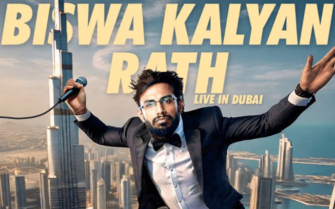 Comedian performing live in Dubai with Burj Khalifa in the background.