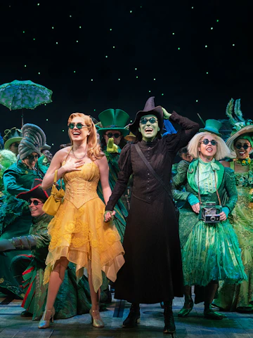 Wicked cast performing on Broadway stage, New York City.