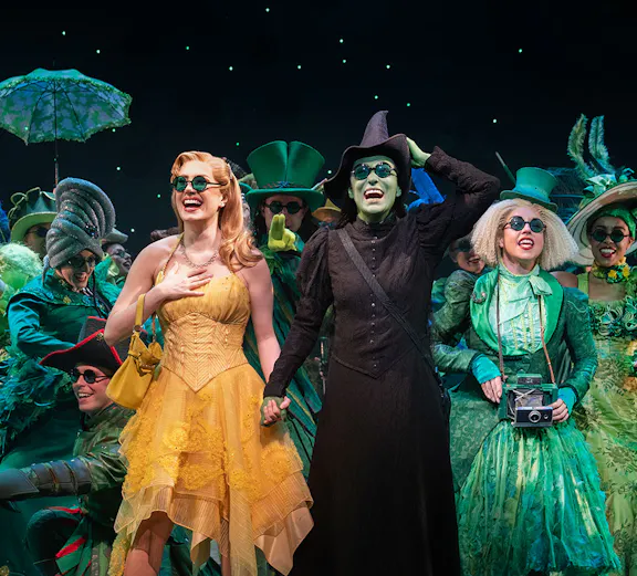 Wicked cast performing on Broadway stage, New York City.