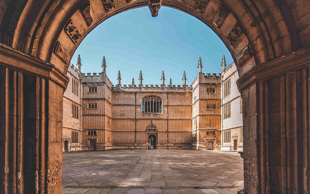 Bodleian Library courtyard in Oxford, viewed through an archway.