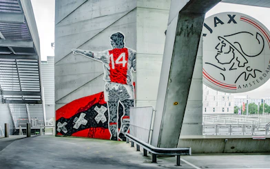 Mural of a football player with number 14 at Johan Cruijff ArenA, Amsterdam.