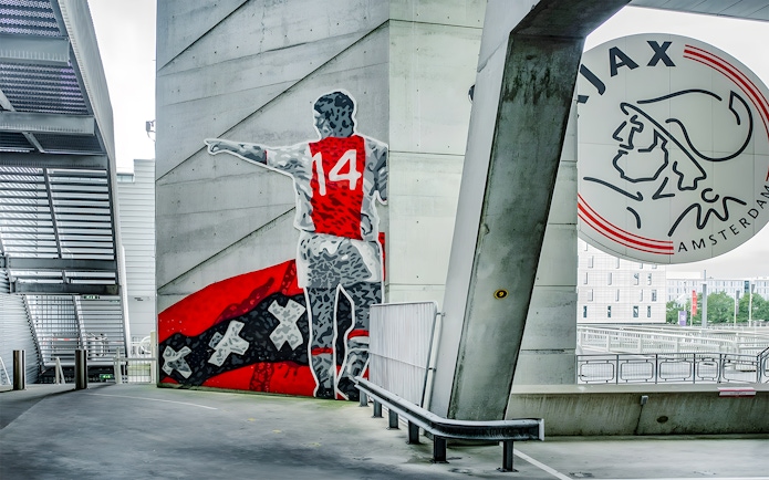 Mural of a football player with number 14 at Johan Cruijff ArenA, Amsterdam.