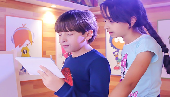 Children engaging in rising star role-play activities at KidZania Abu Dhabi indoor theme park.