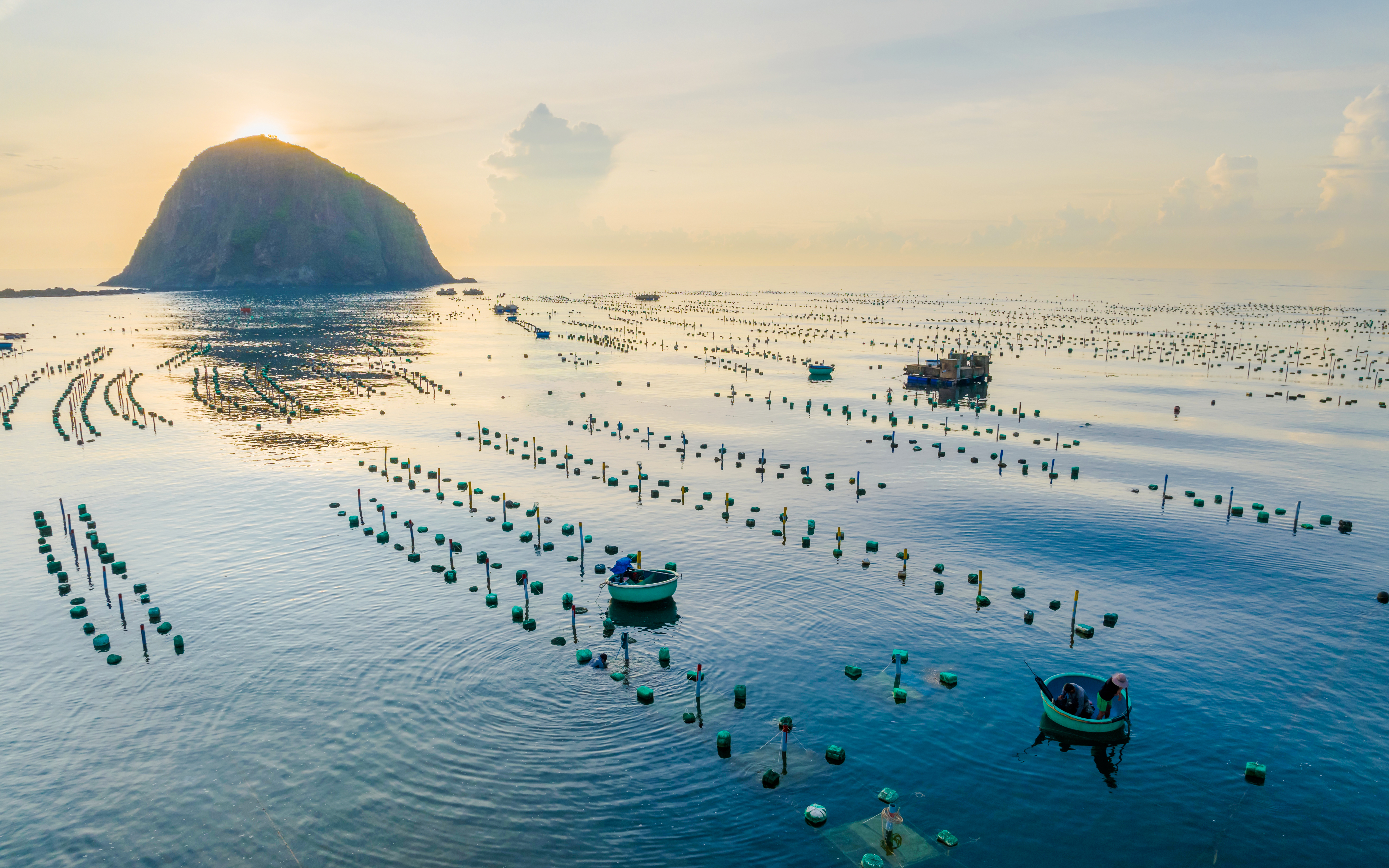 Seascape of Hon Yen Island with fishing boats and seaweed farms, Phu Yen Province, Vietnam.