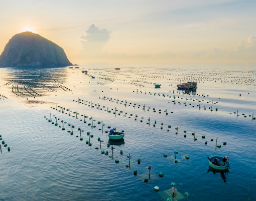 Seascape of Hon Yen Island with fishing boats and seaweed farms, Phu Yen Province, Vietnam.