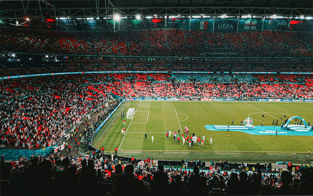 Wembley Stadium filled with fans during a football match, part of the Arsenal FC and Wembley tour combo.