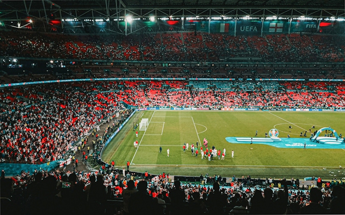 Wembley Stadium filled with fans during a football match, part of the Arsenal FC and Wembley tour combo.