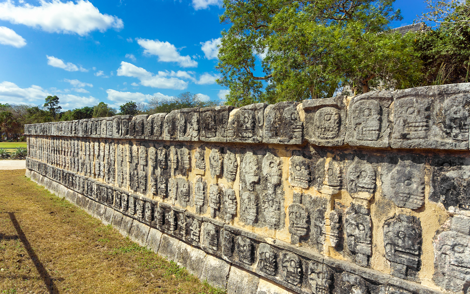 Stone carvings of skulls on the Platforms of the Skulls at Chichen Itza, Mexico.