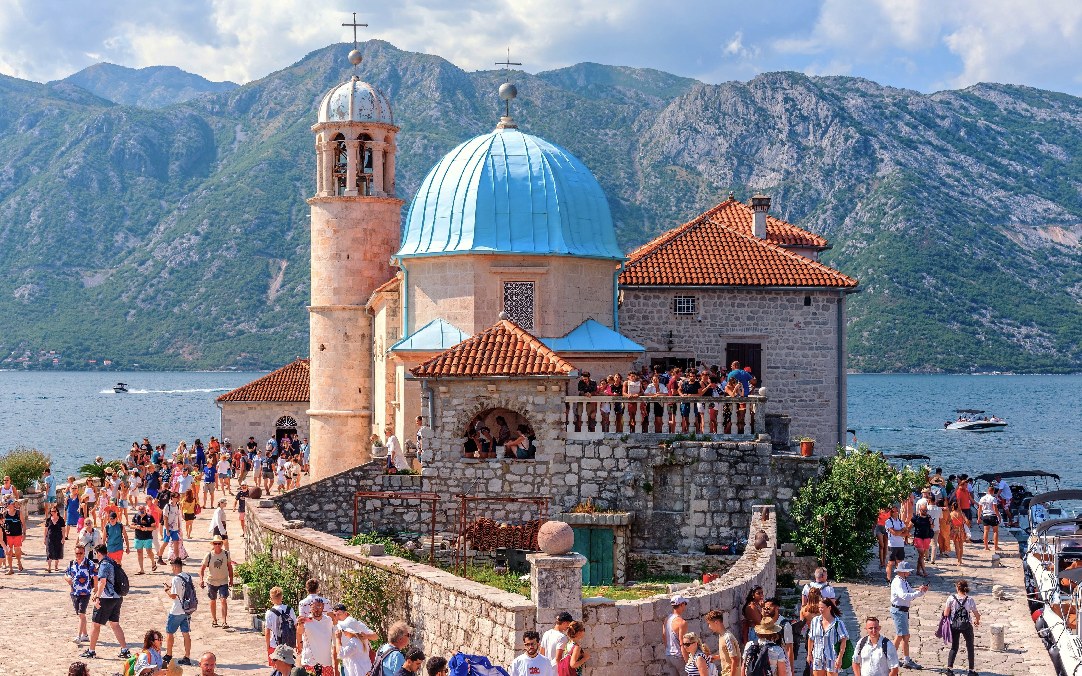 Our Lady of the Rocks church with tourists in Bay of Kotor, Montenegro.