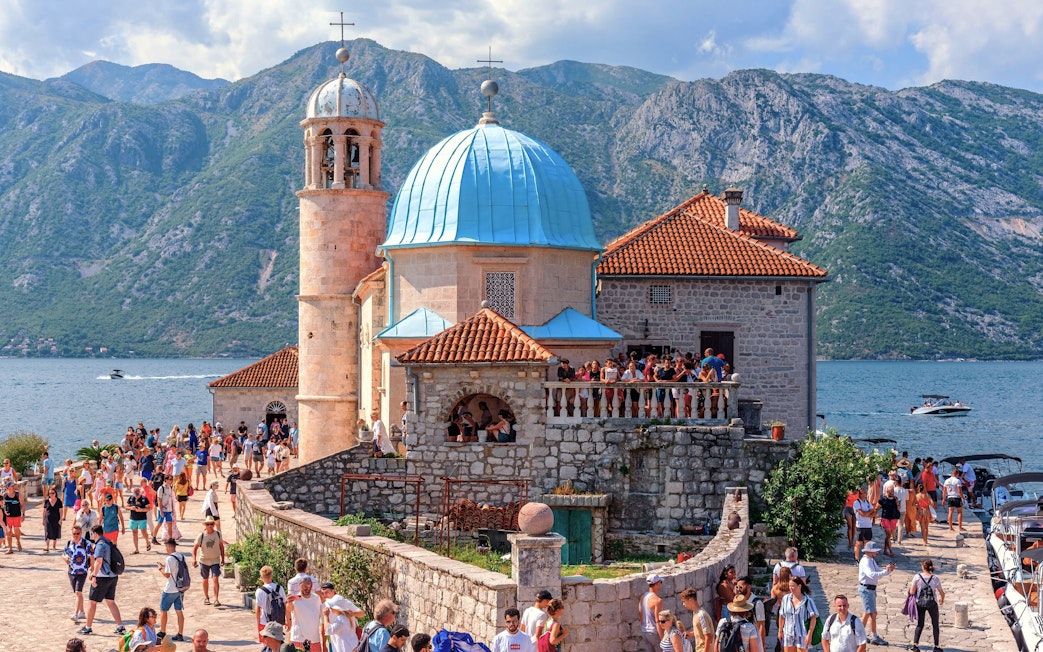 Our Lady of the Rocks church with tourists in Bay of Kotor, Montenegro.