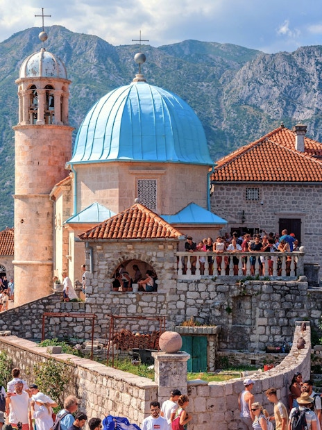 Our Lady of the Rocks church with tourists in Bay of Kotor, Montenegro.