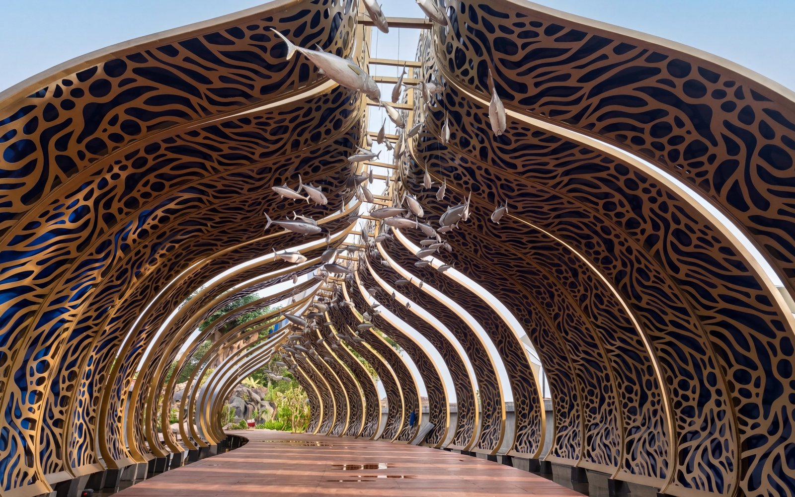 Decorative archway with fish sculptures at Taman Safari Bali.