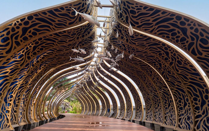 Decorative archway with fish sculptures at Taman Safari Bali.