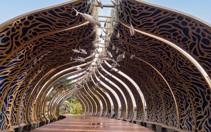 Decorative archway with fish sculptures at Taman Safari Bali.