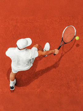 Tennis player on clay court during World Tennis League match.
