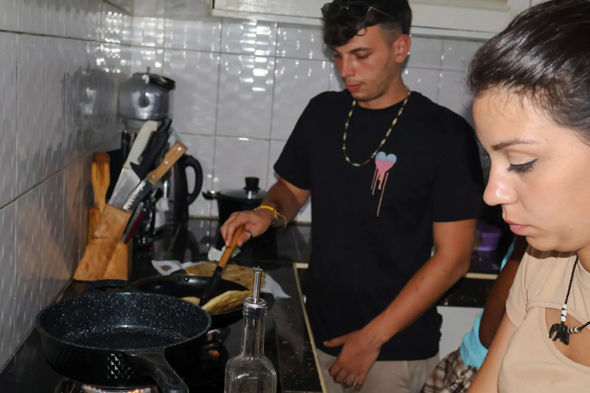 Cooking class participants preparing food in a kitchen at Diani Beach.
