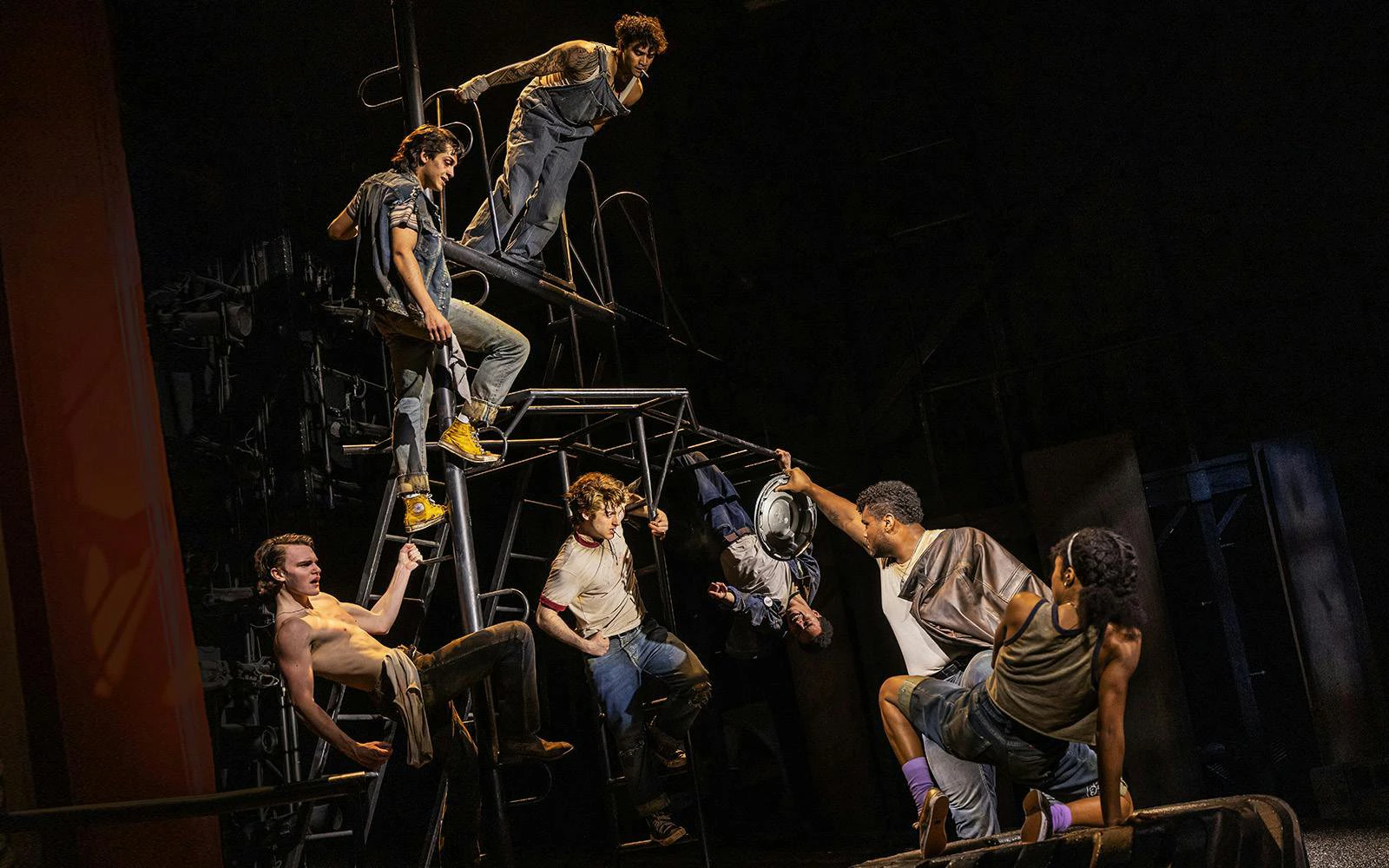 Actors performing a dynamic scene from The Outsiders on Broadway stage.