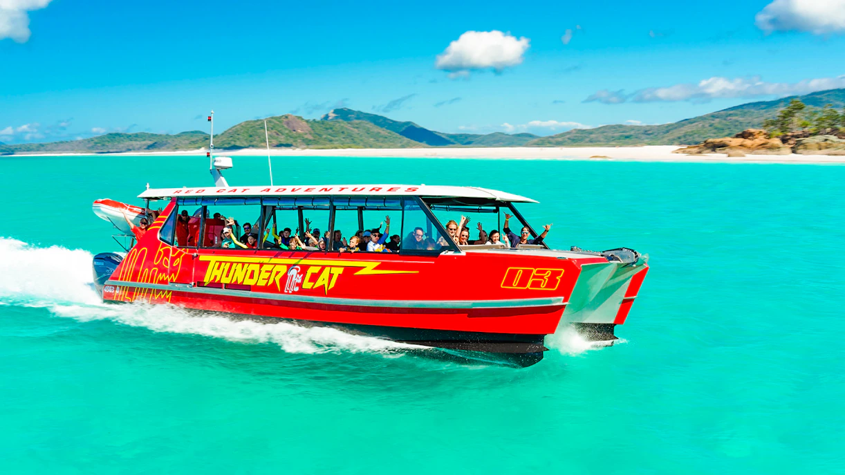 Thundercat boat cruising through turquoise waters in Whitsundays, Australia.