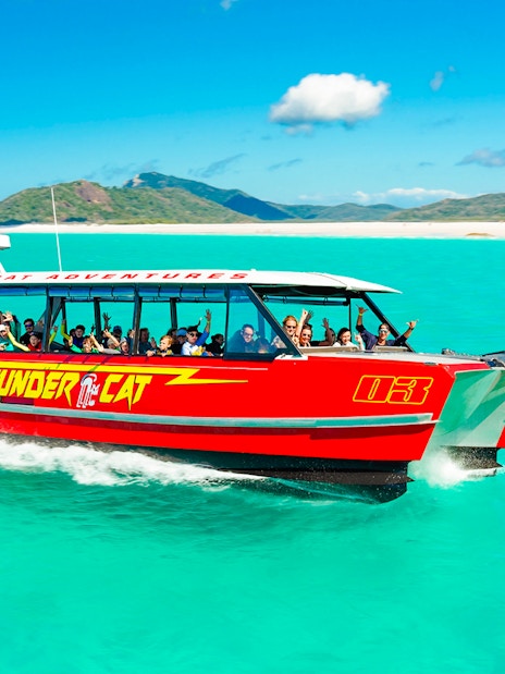 Thundercat boat cruising through turquoise waters in Whitsundays, Australia.