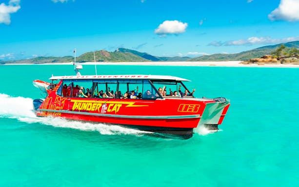 Thundercat boat cruising through turquoise waters in Whitsundays, Australia.