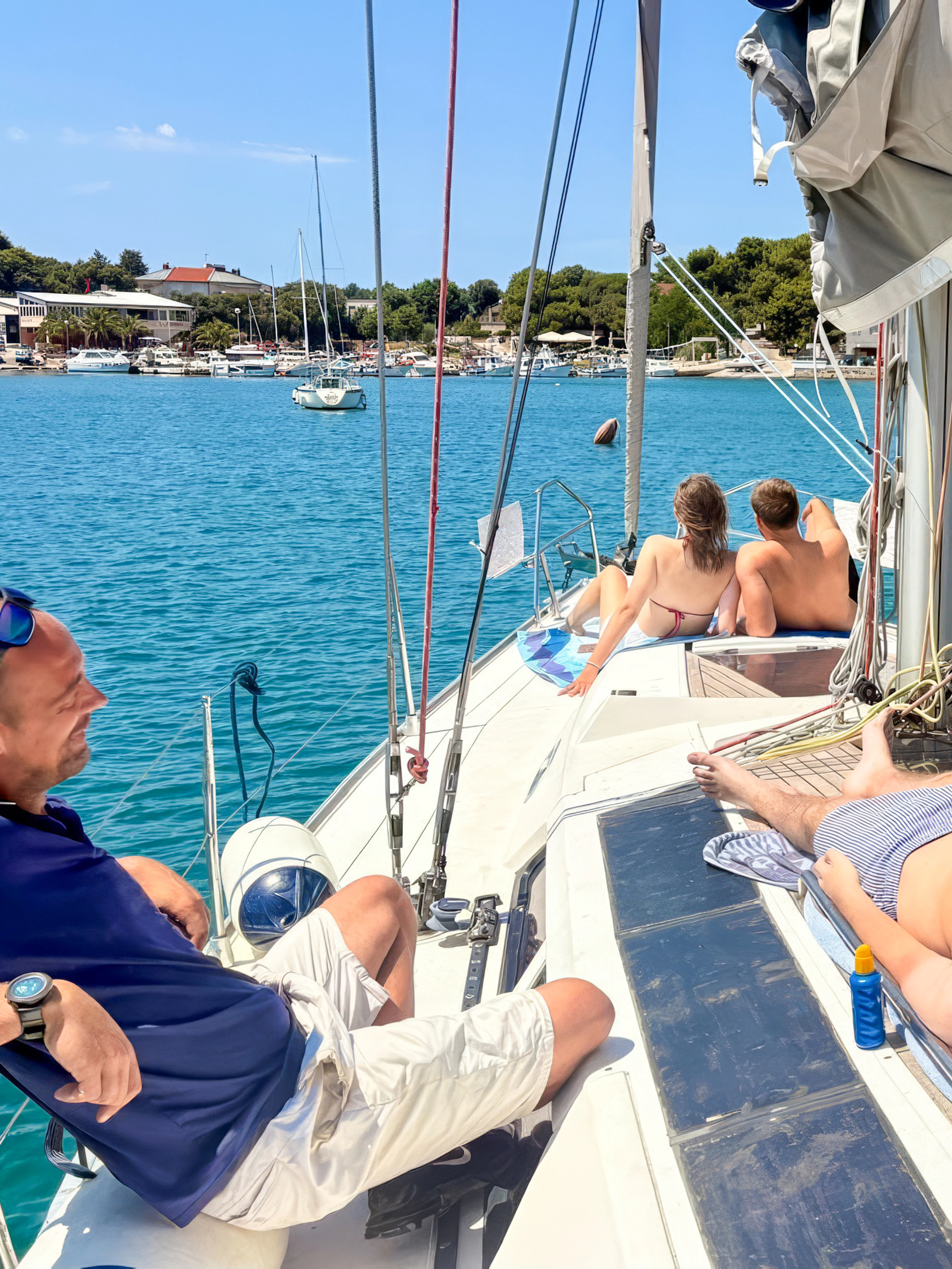 Small group relaxing on a sailboat in Pula, Croatia, during Brijuni sunset and dolphin tour.