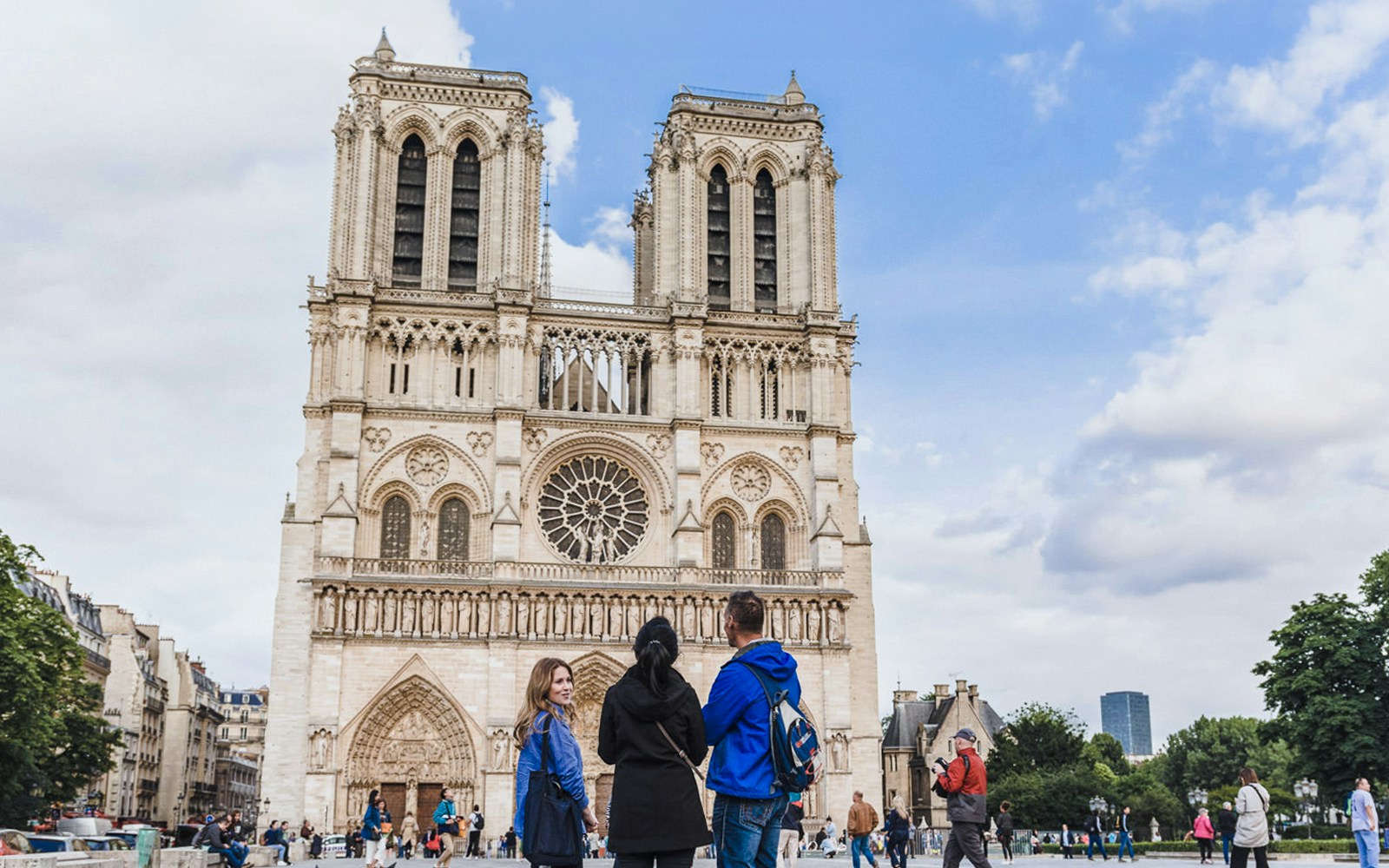 Notre Dame Cathedral with tourists on a guided tour in Paris.