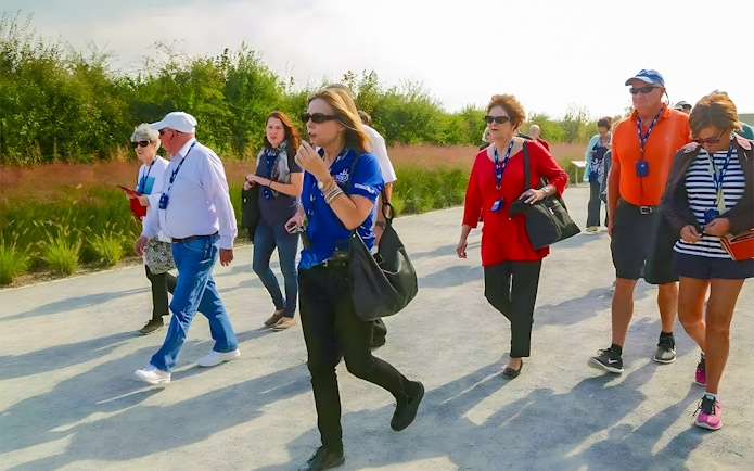 Tour group walking on a path during the D-Day Normandy Beaches guided tour.