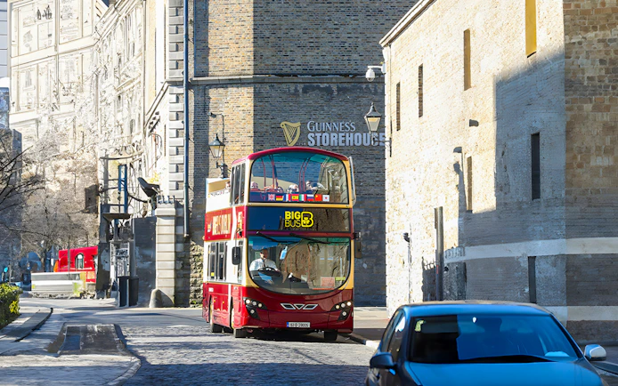 Red double-decker bus near Guinness Storehouse in Dublin.