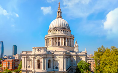 St. Paul's Cathedral dome with London skyline on a sunny day.