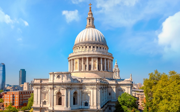 St. Paul's Cathedral dome with London skyline on a sunny day.