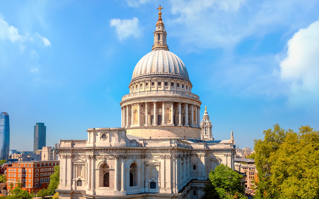 St. Paul's Cathedral dome with London skyline on a sunny day.