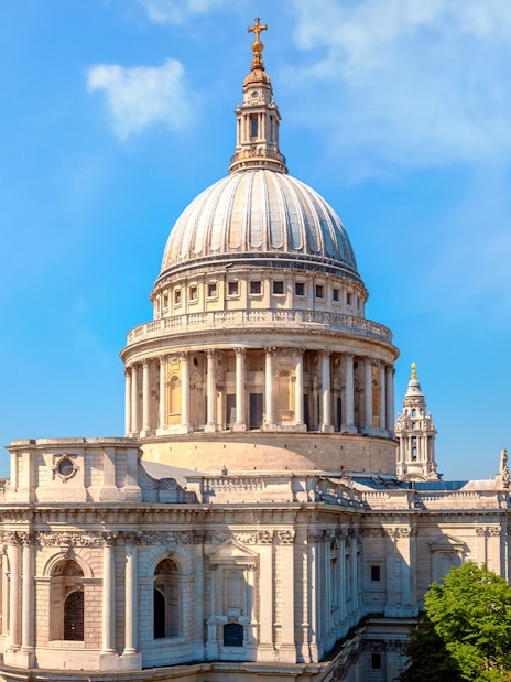 St. Paul's Cathedral dome with London skyline on a sunny day.